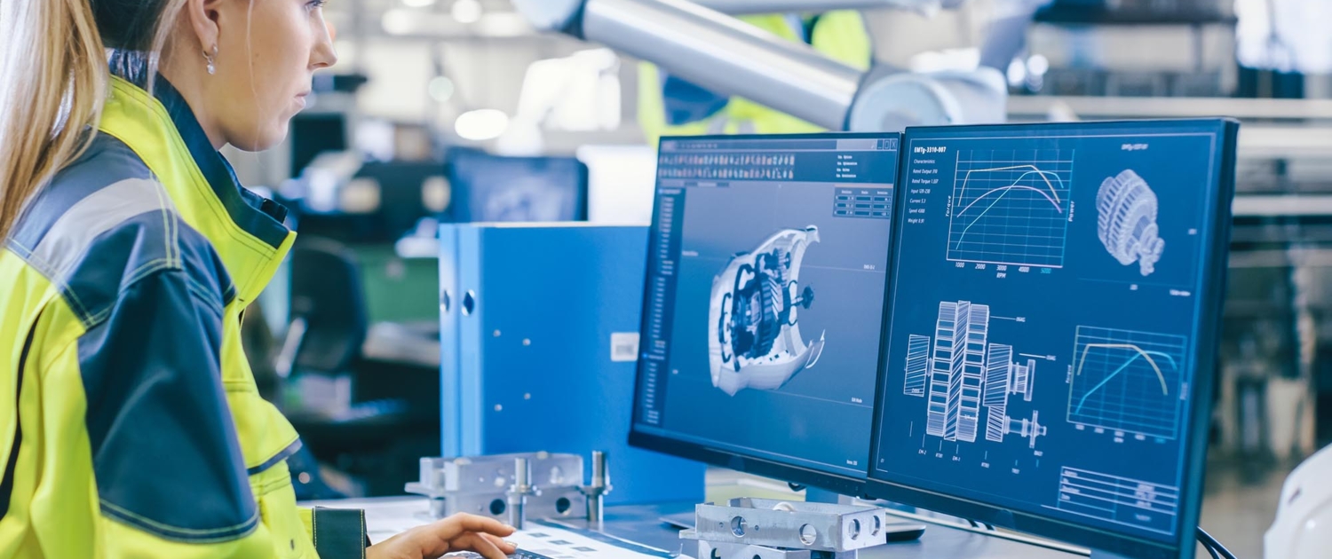 Engineer working on 3D models of parts on computer